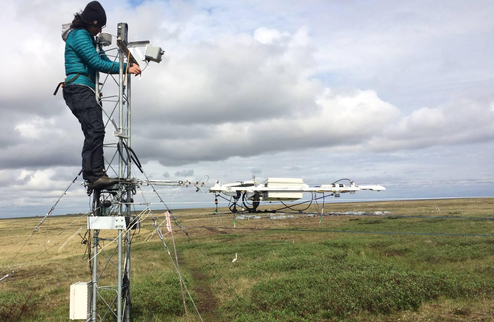 researcher fixing equipment at Atqasuk Alaska